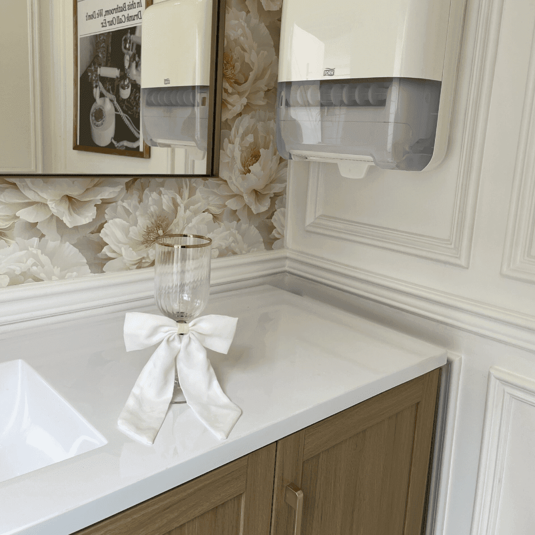 Interior of a Toiluxe 2-station luxury restroom trailer featuring wood vanities, gold fixtures, and hotel-style amenities for an Ontario wedding