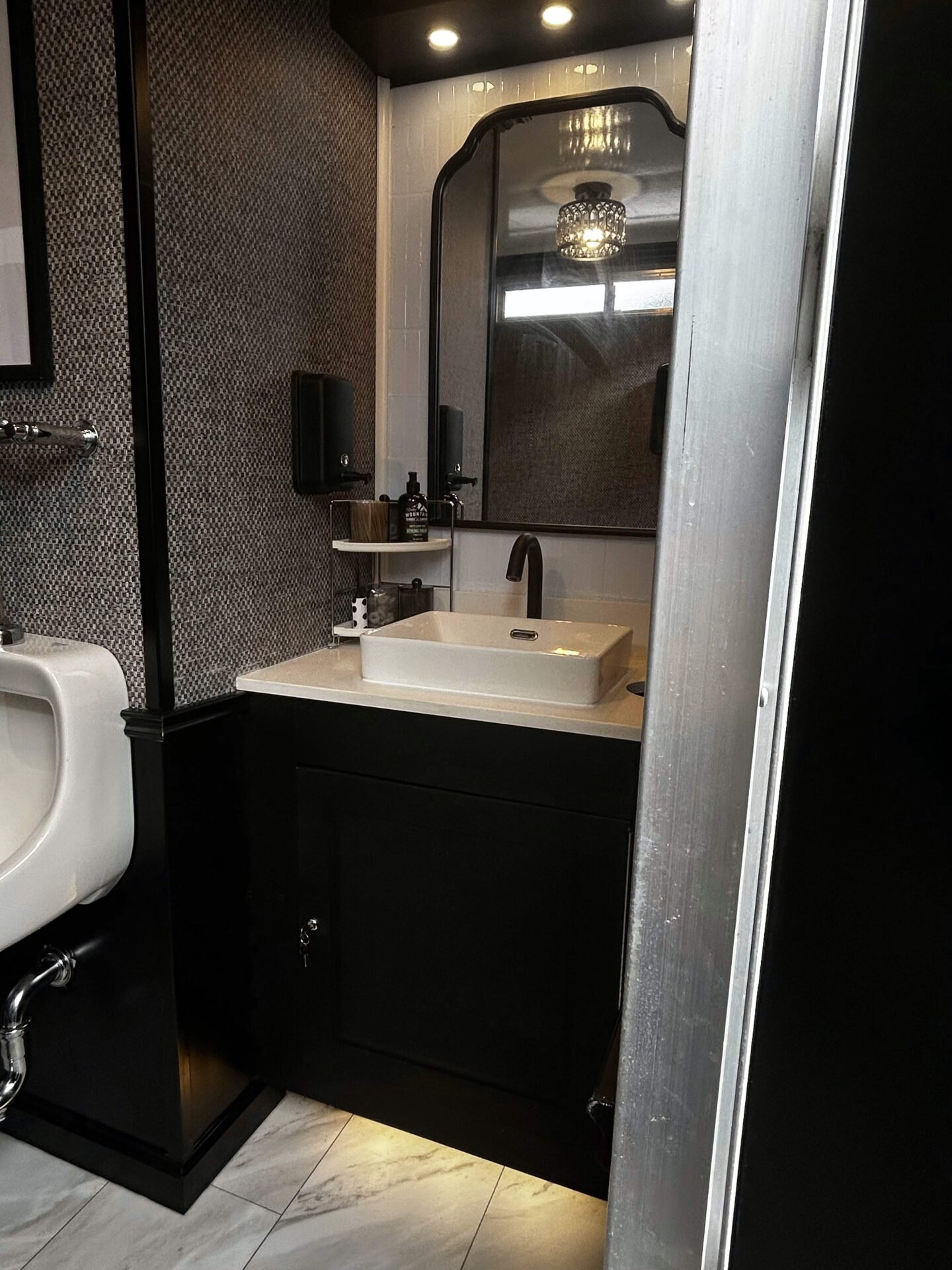 Side view of sink vanity inside a luxury mobile restroom trailer