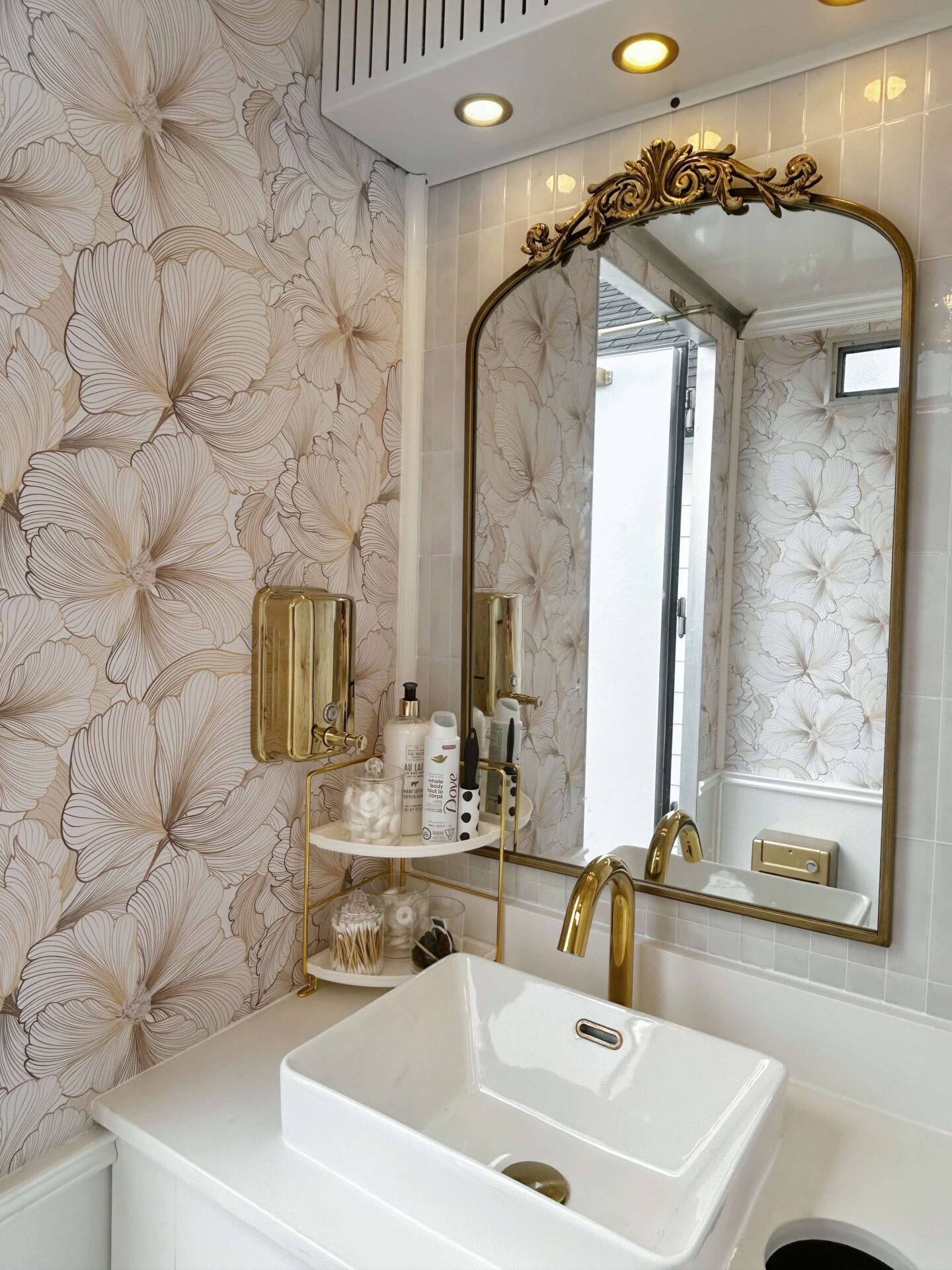 Elegant vanity with gold mirror inside a luxury mobile restroom trailer by Toiluxe in Ontario