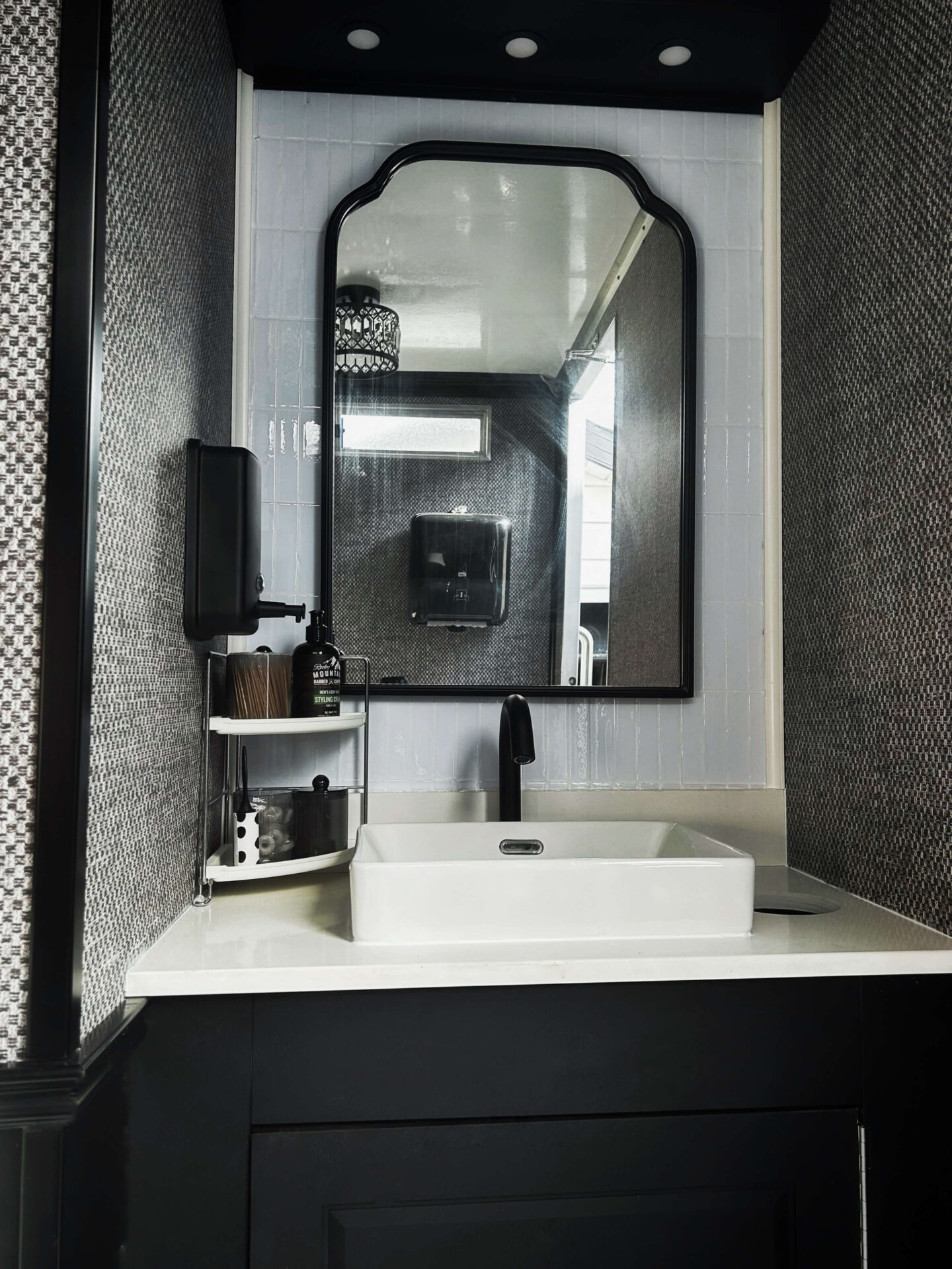 Front view of luxury restroom trailer vanity with modern lighting