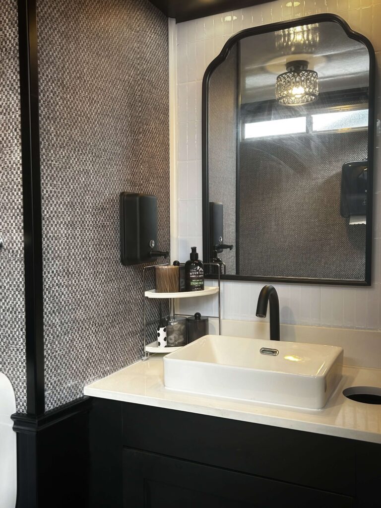 Homepage 8 Dark vanity and mirror design inside a luxury restroom trailer bathroom