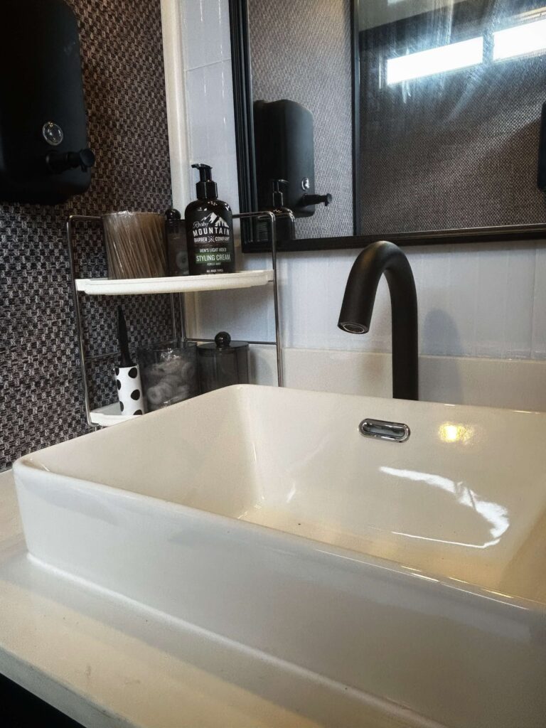 Homepage 10 Modern dark interior sink inside a luxury mobile restroom trailer bathroom