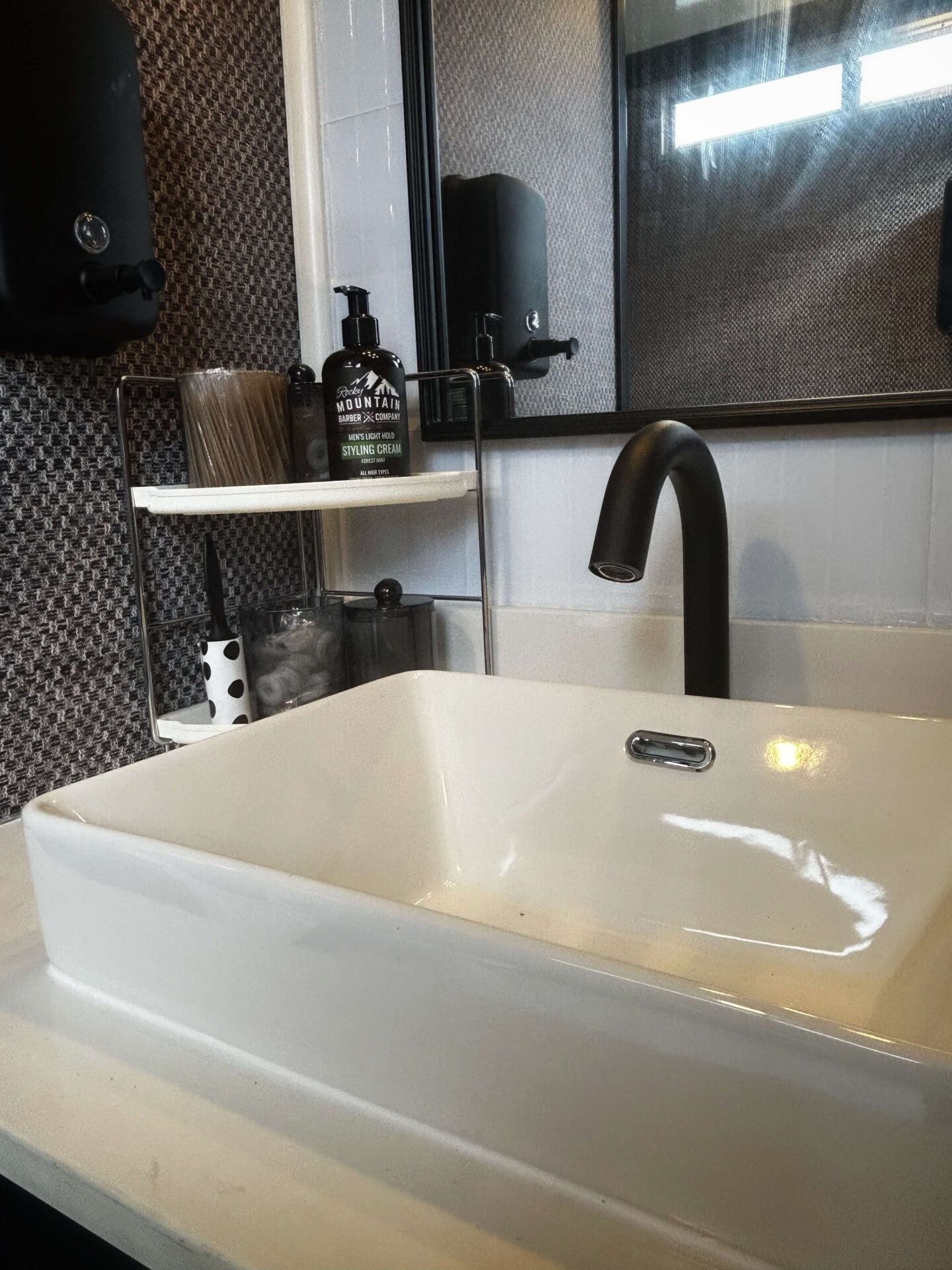Modern dark interior sink inside a luxury mobile restroom trailer bathroom
