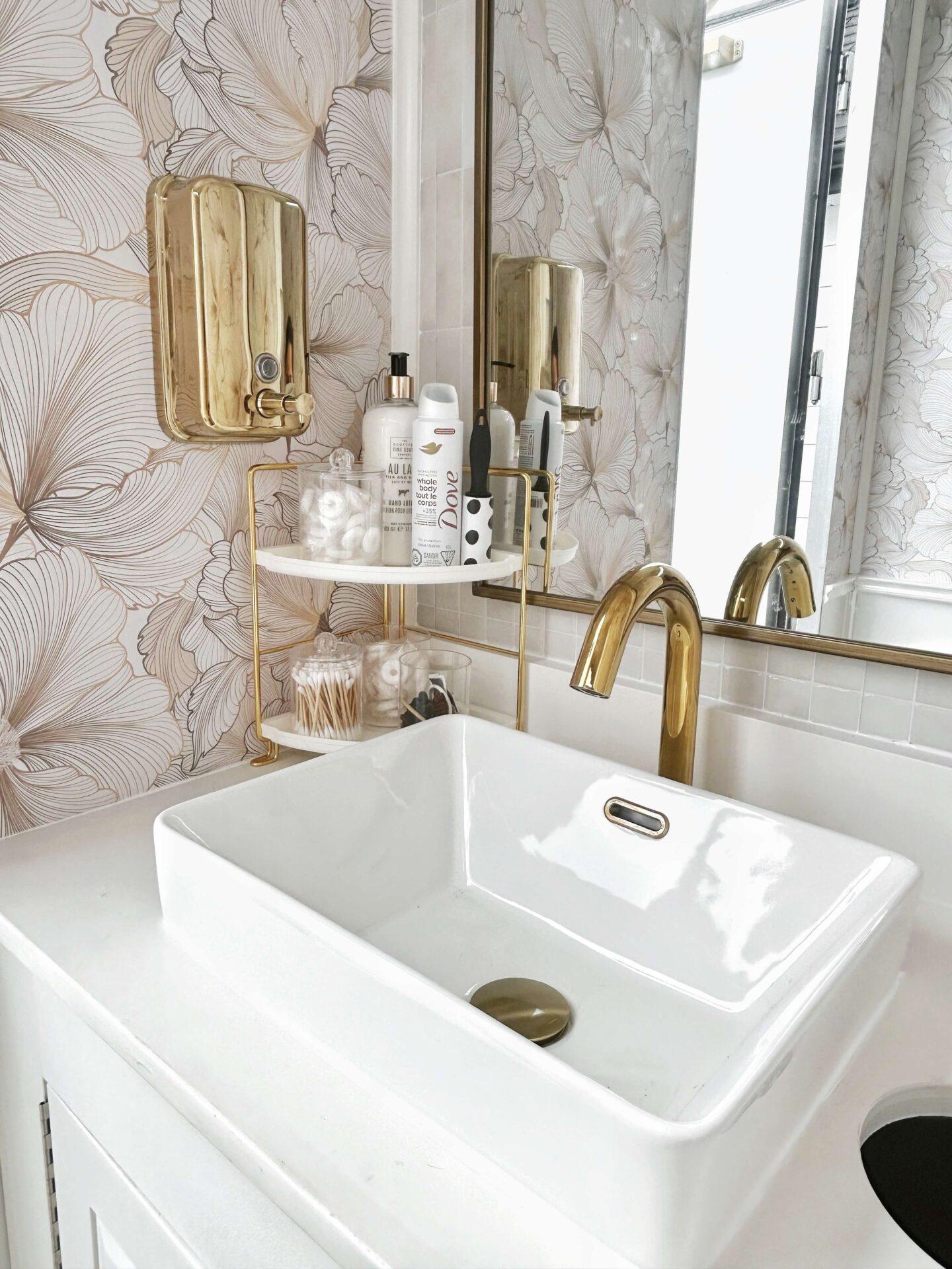 Luxury restroom trailer sink with gold faucet and marble style wall finish