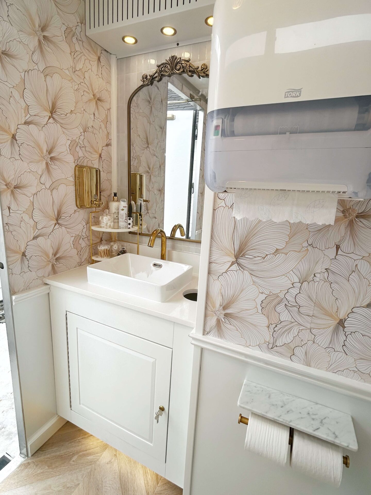 Luxury restroom trailer vanity cabinet and sink interior designed for upscale events and weddings