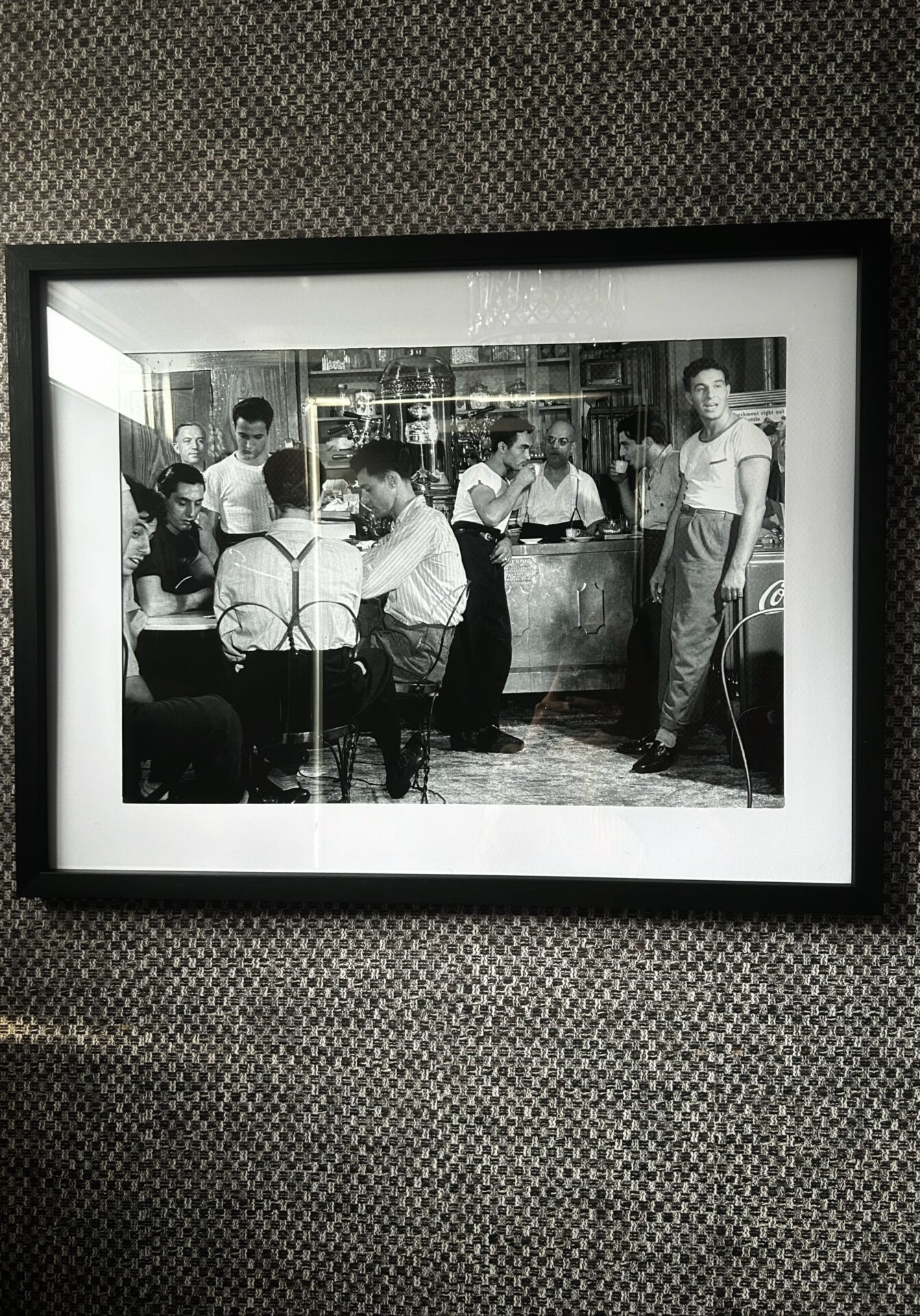 Vintage black and white barbershop wall art decorating the men's washroom inside a Toiluxe luxury mobile restroom trailer.