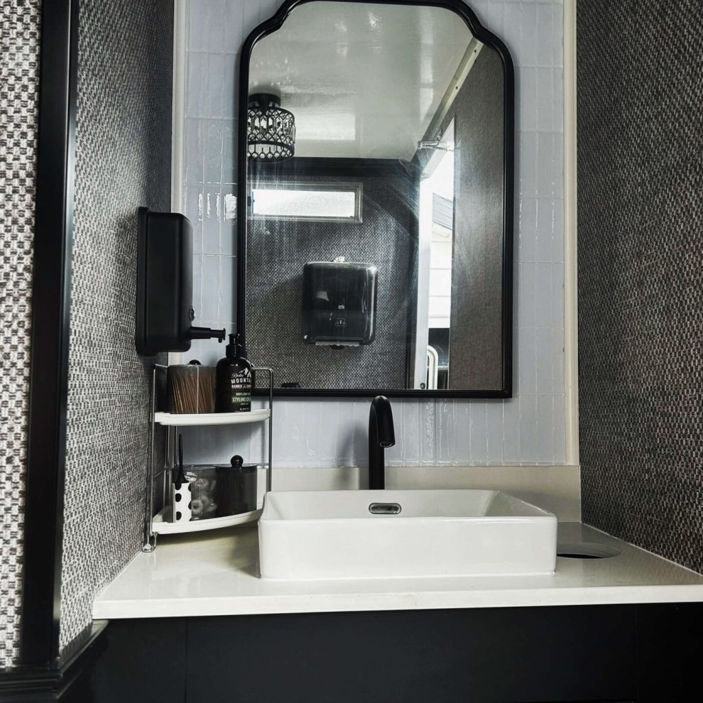 Front view of luxury restroom trailer vanity with modern lighting