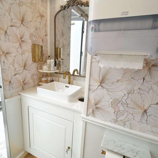 Luxury restroom trailer vanity cabinet and sink interior designed for upscale events and weddings