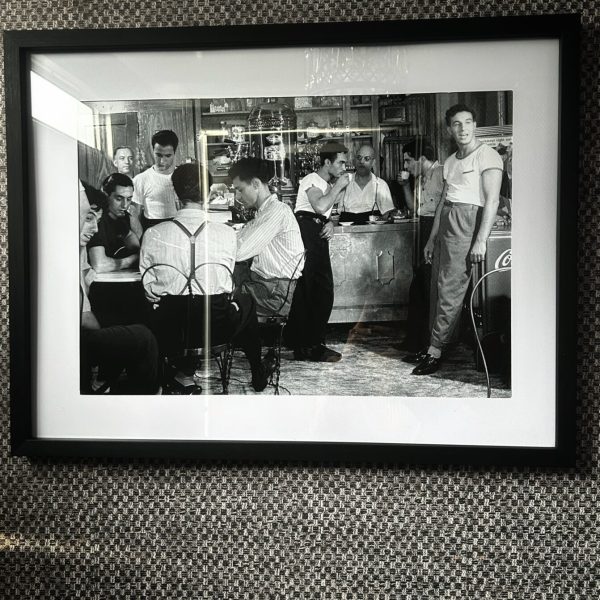 Vintage black and white barbershop wall art decorating the men's washroom inside a Toiluxe luxury mobile restroom trailer.